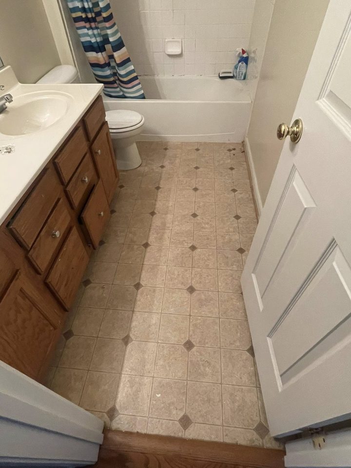 Bathroom remodel with tile floor and wood vanity