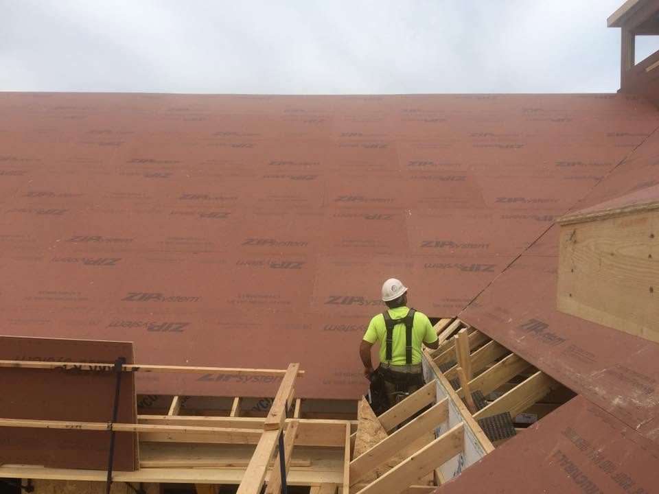 Uncle Dino Construction crew member installing roof sheathing